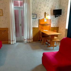 - un salon avec une table en bois et un bureau dans l'établissement Delizioso monolocale, à Dobbiaco