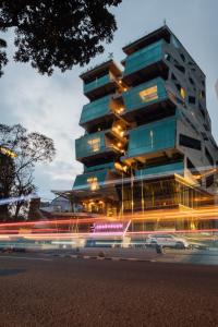 a tall building with light streaks in front of it at Janevalla Bandung in Bandung