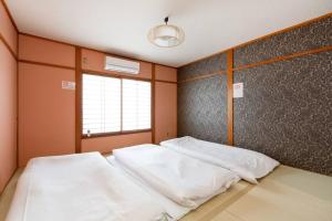Ένα ή περισσότερα κρεβάτια σε δωμάτιο στο LJ Inn Fushimi Inari伏見稲荷