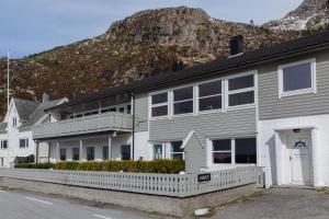 a house with a mountain in the background at Havly Bed & Breakfast in Hauge