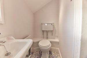 a white bathroom with a toilet and a sink at Host & Stay - Peacock House in Tynemouth