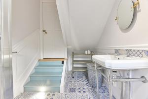 a bathroom with a sink and a staircase at Host & Stay - Peacock House in Tynemouth
