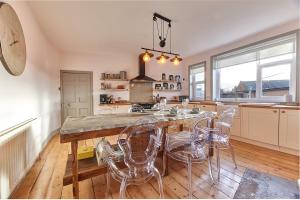 a kitchen with a large table and chairs in it at Host & Stay - Peacock House in Tynemouth