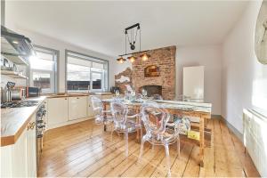 a kitchen with a table and chairs and a fireplace at Host & Stay - Peacock House in Tynemouth +10 photos