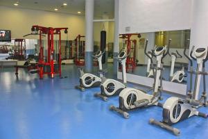 a gym with a bunch of cardio equipment in it at 107 - Two-Bedroom Beach Apartment in Estepona