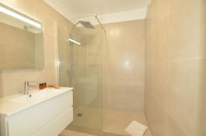 a bathroom with a shower and a sink at La Perle d'Eze - Aparthotel in Éze