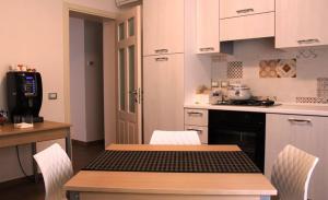 a kitchen with a table with chairs and a stove at B&B Al Viale in Macerata