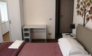 a bedroom with a bed and a table and a desk at B&B Al Viale in Macerata