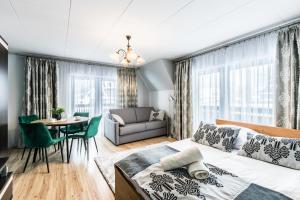 a bedroom with a bed and a dining room at Willa u Baranów in Zakopane