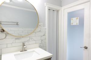a bathroom with a sink and a mirror at Best XL Home To Visit NYC+Hot Tub+Newark Airport+Free Parking in Hillside +60 photos