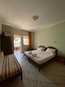 a bedroom with a large bed and a couch at Eliros Studios in Stalos +114 photos