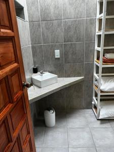 a bathroom with a sink and a mirror at Santika Villa Stellenbosch in Stellenbosch