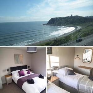 a bedroom with two beds and a view of the ocean at North Sea View Apartment in Scarborough