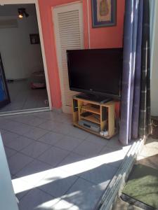 a flat screen tv sitting on a stand in a living room at Josip 1 Gajac in Novalja
