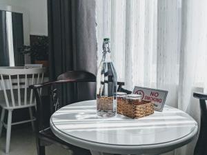 a bottle of wine and a no smoking sign on a table at Tuấn Ninh Hotel I in Con Dao