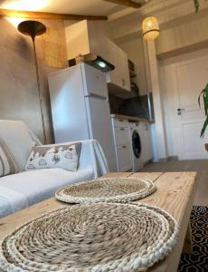 a living room with a table with a couch and a refrigerator at Lovely 1 Bedroom Apartment - Heart of Nice in Nice