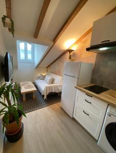 a kitchen with a white refrigerator and a couch at Lovely 1 Bedroom Apartment - Heart of Nice in Nice