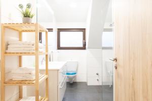een badkamer met een wastafel en een plank met handdoeken bij Schäfer's Ferienhof Michaelsberg in Gundelsheim