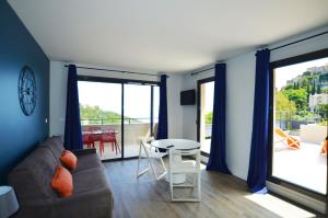 a living room with a couch and a table at La Perle d'Eze - Aparthotel in Éze