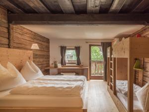 a bedroom with a bed and a window at Chalet Wolfbachgut in Taxenbach