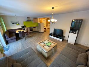 a living room with a couch and a table at Ferienwohnung Sonnenaufgang in Amtzell