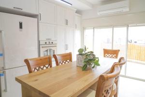 a kitchen with a wooden table and chairs at נווה חרמון in Majdal Shams
