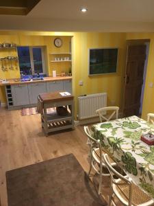 a living room with a table and a kitchen at Charming 3-Bed House in Abergele Wales UK in Abergele
