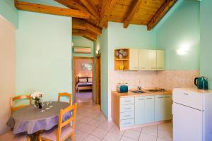 a kitchen with a table and a dining room at Apartments Vodnica in Zaton