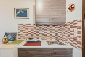 a kitchen with a sink and a counter top at Notos Studios in Laganas