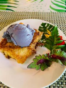 a plate of food with a ice cream on it at Pension TUPUNA in Haapu