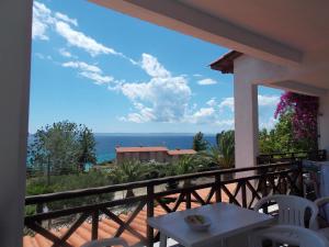 a balcony with a table and a view of the ocean at Helios Land in Neos Marmaras
