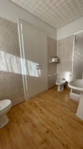 a bathroom with two sinks and a toilet and a sink at Hotel Ristorante Genzianella in Madonna di Campiglio