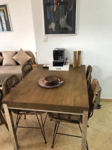 a wooden table with a plate on it in a living room at Torrox Pueblo Hidden Gem, 2 Bed Apartment in Torrox