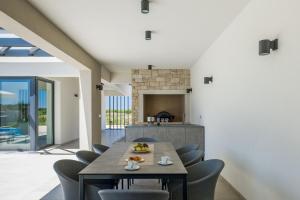 a dining room with a table and chairs at Villa Bella by SeeAdria Agency in Brtonigla