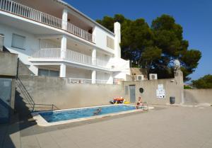 two people in a swimming pool in front of a building at Treputxell 1-1 in L'Estartit