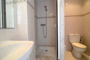 a bathroom with a tub and a toilet and a shower at Treputxell 1-1 in L'Estartit +14 photos