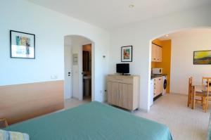 a bedroom with a bed and a dining room at Treputxell 1-1 in L'Estartit