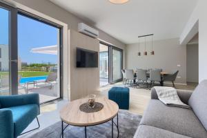 a living room with a couch and a table at Villa Bella by SeeAdria Agency in Brtonigla