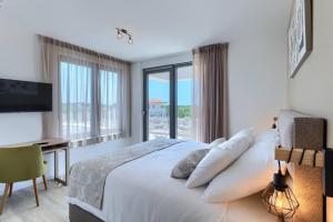 a bedroom with a bed and a desk and window at Villa Bella by SeeAdria Agency in Brtonigla +75 photos