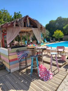 a bar on a deck next to a pool at Finca Fahala in Cártama