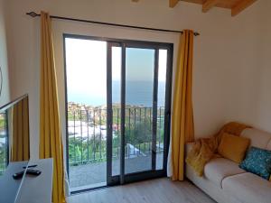 a living room with a sliding glass door at Ponta do Sol Private Apartment Sea View in Ponta do Sol