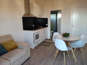 a living room with a couch and a table at Ponta do Sol Private Apartment Sea View in Ponta do Sol