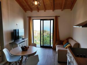 a living room with a table and a couch at Ponta do Sol Private Apartment Sea View in Ponta do Sol
