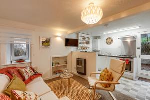 a living room with a couch and a kitchen at Georgian period property w/large enclosed garden in Crieff