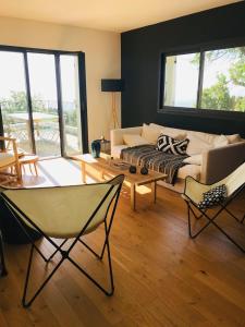 a living room with a couch and a table and chairs at Villa Poggio in Santa-Maria-Poggio