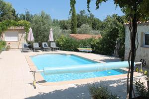 a swimming pool with a large blue inflatable at Le bonheur au soleil in Saint-Maximin-la-Sainte-Baume