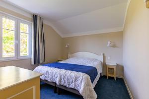 a small bedroom with a bed and a window at Maison pour 6 - Piscine - Port Bourgenay in Talmont-Saint-Hilaire +16 photos