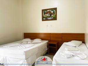 Ein Bett oder Betten in einem Zimmer der Unterkunft Hotel Estação de Minas
