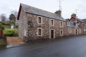 an old stone house on the side of a street at Georgian period property w/large enclosed garden in Crieff