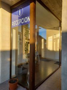 a store front window with a reflection of a table at Apartamentos Playa de Portio in Liencres